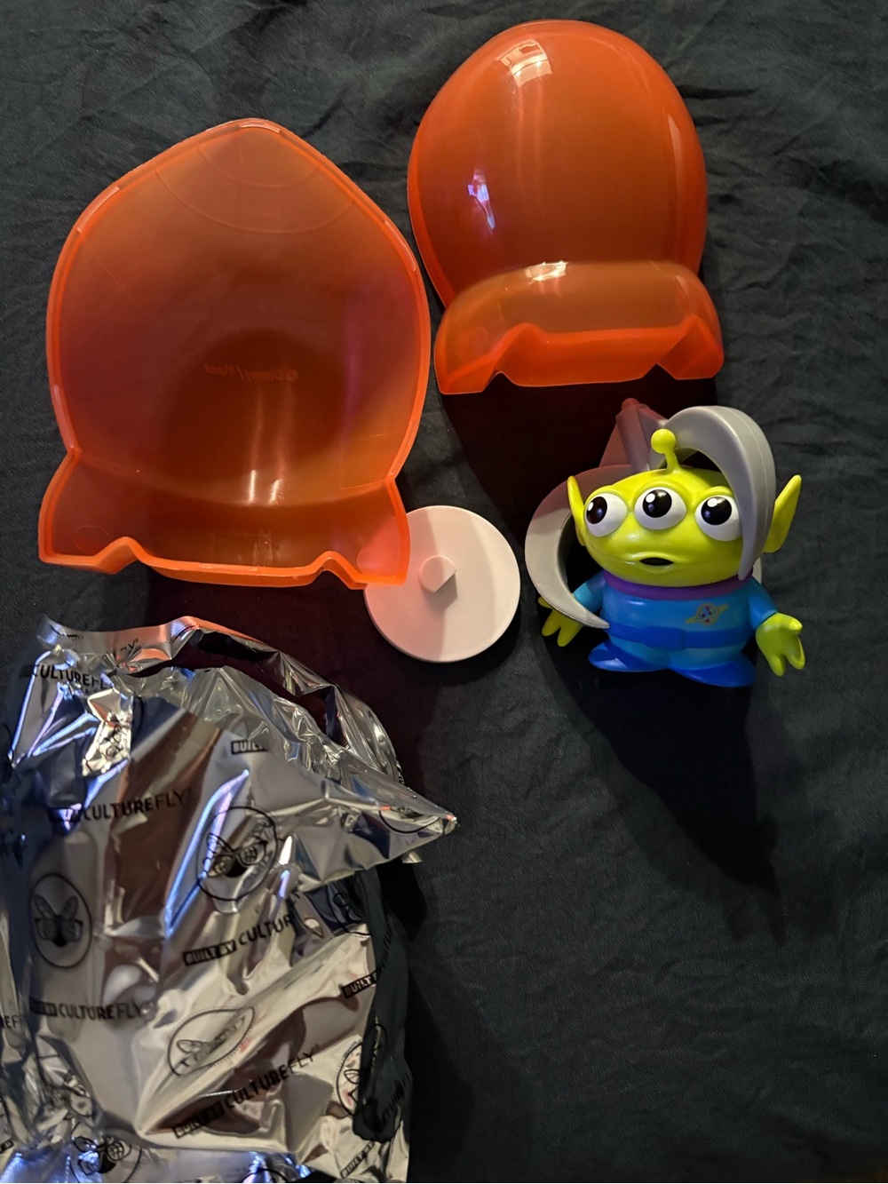 Green Three-Eyed Alien Figure with Orange Capsule Play Case